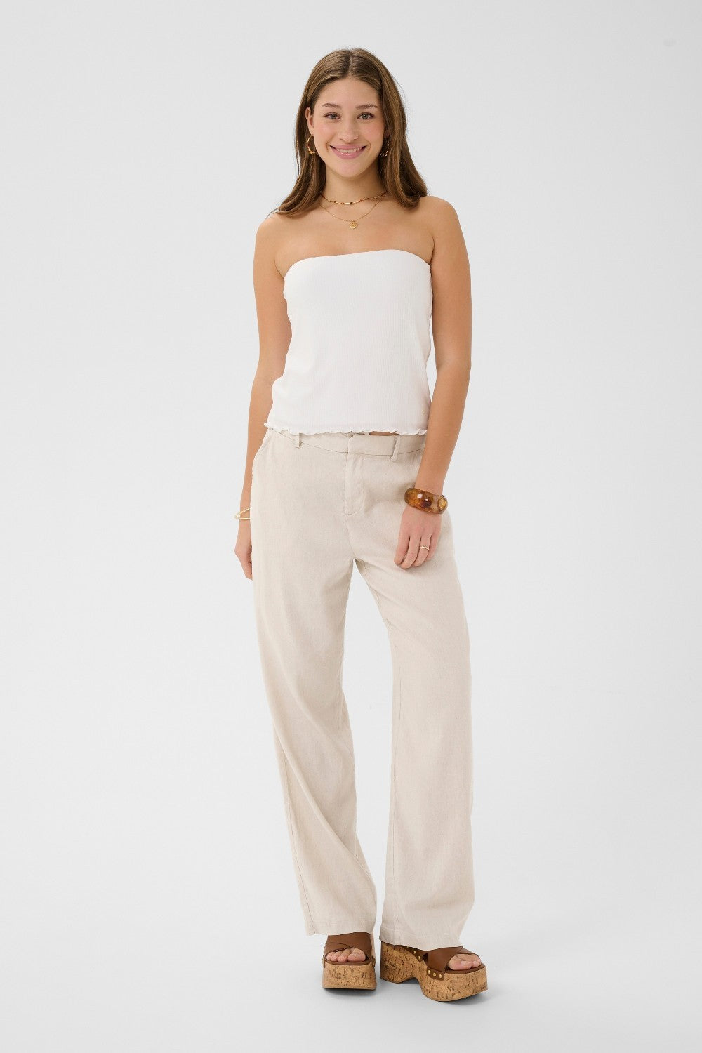 The Cream June Pant is your summer wardrobe essential. This lightweight linen blend dress pant offers breathable comfort without sacrificing polish. Designed to move with you through warm months while maintaining a refined, put-together look.