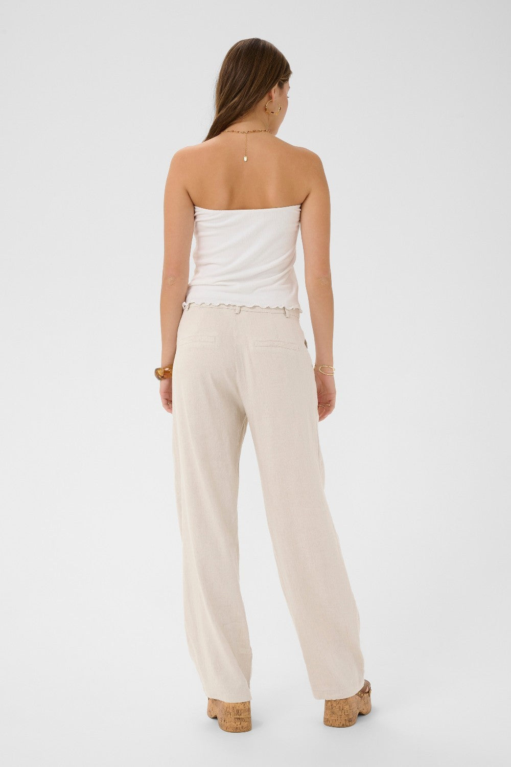The Cream June Pant is your summer wardrobe essential. This lightweight linen blend dress pant offers breathable comfort without sacrificing polish. Designed to move with you through warm months while maintaining a refined, put-together look.