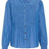 Blue shirt with smocked details on a white background