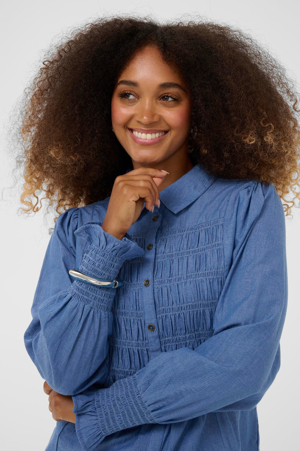 Woman wearing a blue blouse with a white background