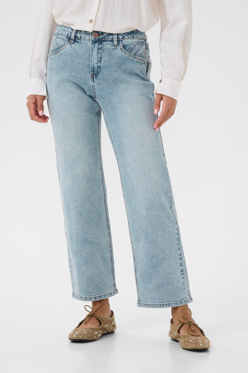 Light blue jeans worn by a person on a white background