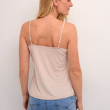 The Cream Lissandra Sliptop is an essential everyday cami designed for versatile layering. This sophisticated piece provides extra coverage beneath sheer tops while maintaining a sleek silhouette. The neutral tone ensures seamless integration with your existing wardrobe, making it an indispensable foundation garment for creating polished, layered ensembles.
