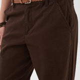 Brown pants with a woven belt on a white background