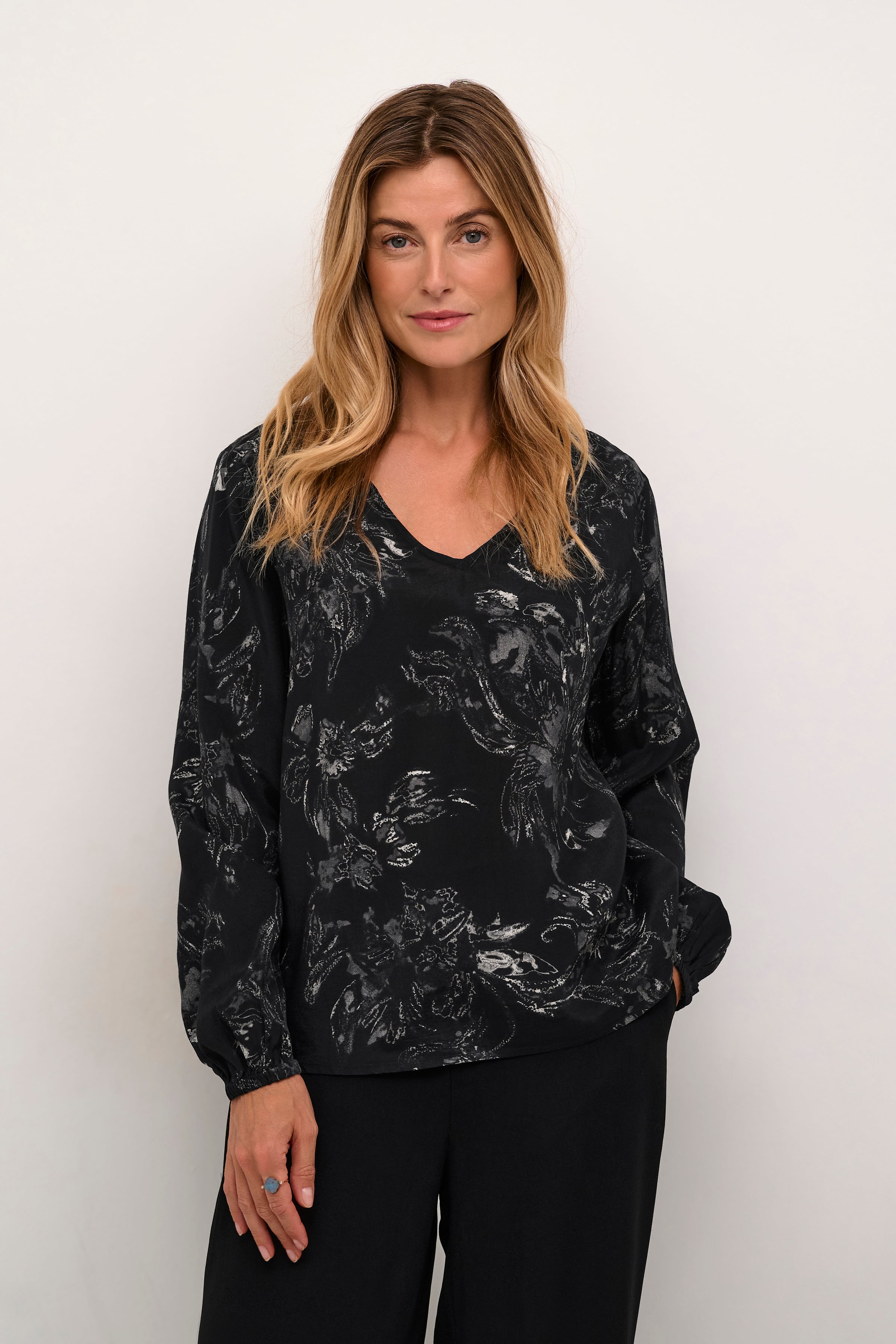 Upgrade your wardrobe with the Cream Lova V-Neck Blouse. This subtle and interesting print adds a touch of sophistication to any outfit. Elevate your style game with this versatile and stylish top.