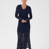 Woman wearing a navy blue lace dress on a white background
