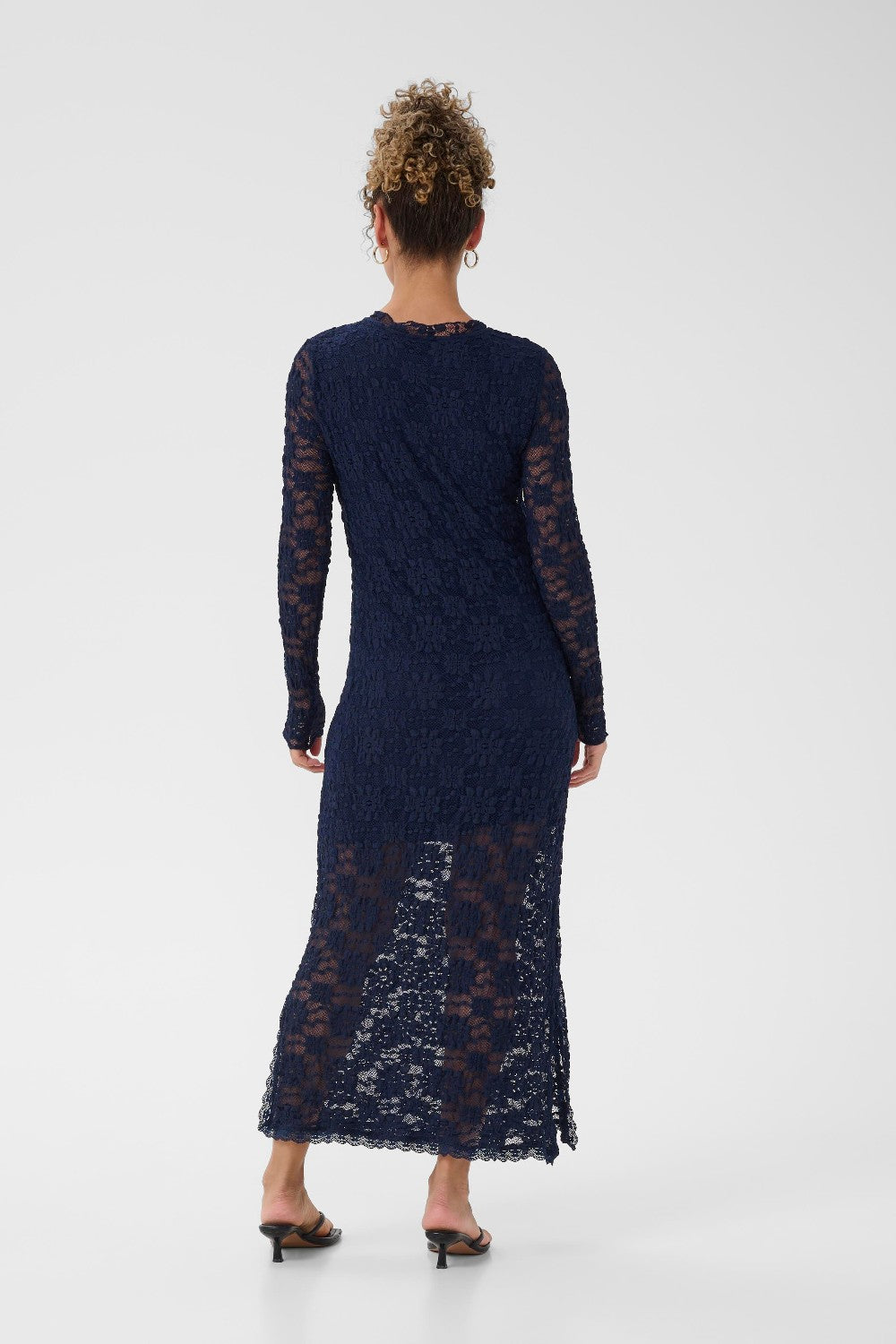 Navy lace dress worn by a model on a white background