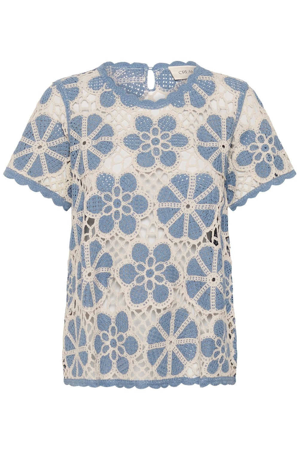 Crochet top with blue floral patterns on a white background