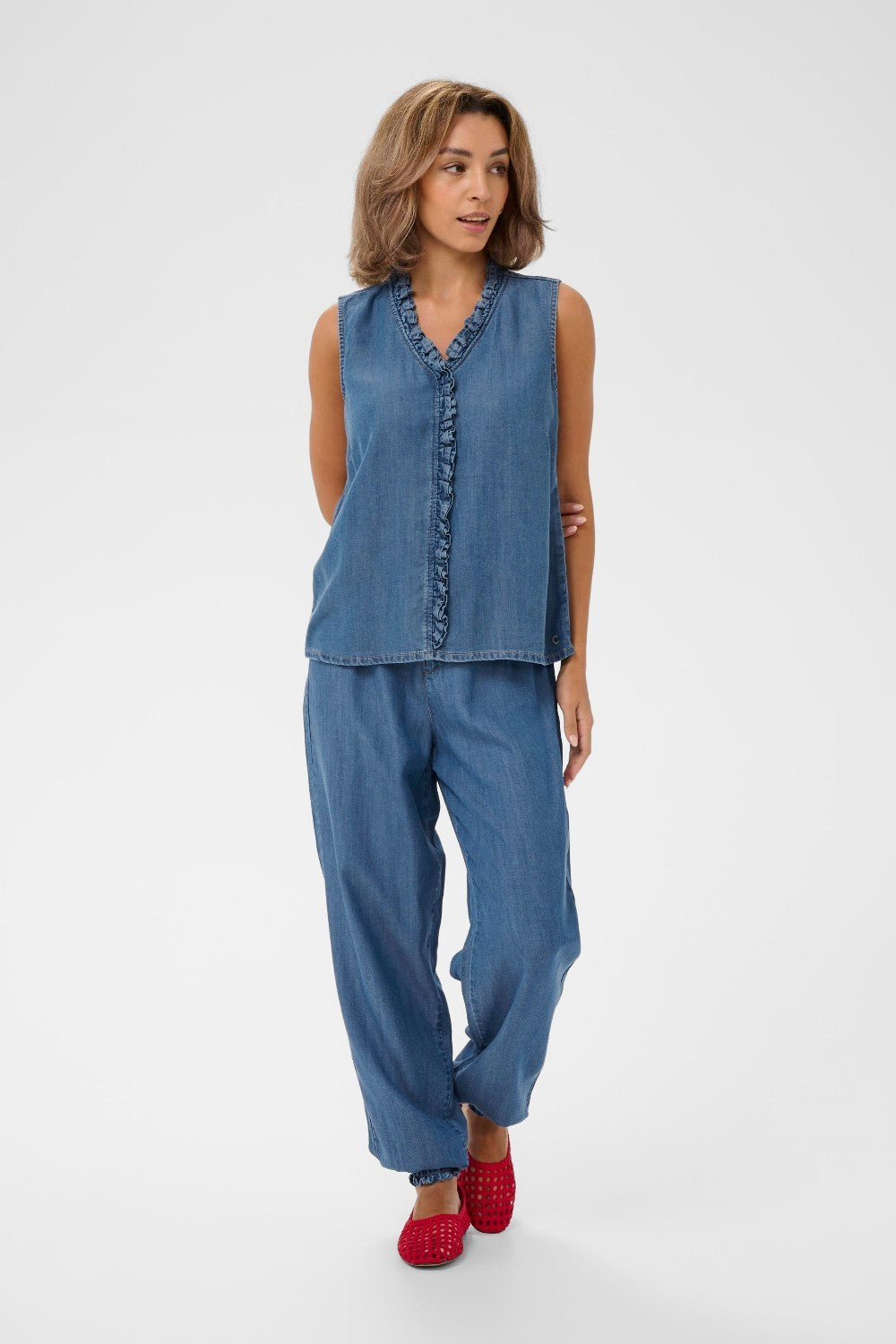 Woman wearing a denim outfit with a white background