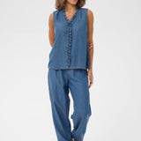 Woman wearing a denim outfit with a white background