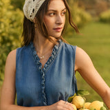 Woman holding a basket of lemons in an outdoor setting