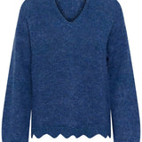 Blue sweater with scalloped hem on a white background