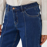 Blue jeans worn by a person on a white background