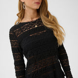 Woman wearing a black top against a white background