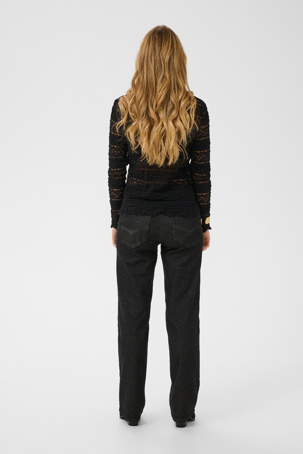 Person wearing a black outfit on a white background