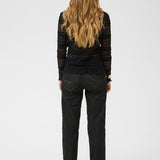 Person wearing a black outfit on a white background