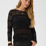 Woman wearing a black top against a white background