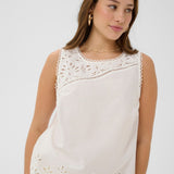 Made from 100% cotton, this top features delicate eyelet detailing that adds a touch of feminine charm to any outfit. 