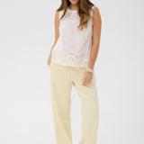 Made from 100% cotton, this top features delicate eyelet detailing that adds a touch of feminine charm to any outfit. 