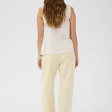 Made from 100% cotton, this top features delicate eyelet detailing that adds a touch of feminine charm to any outfit. 