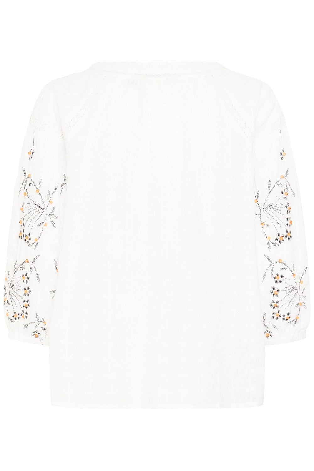 White top with floral embroidery on a white background