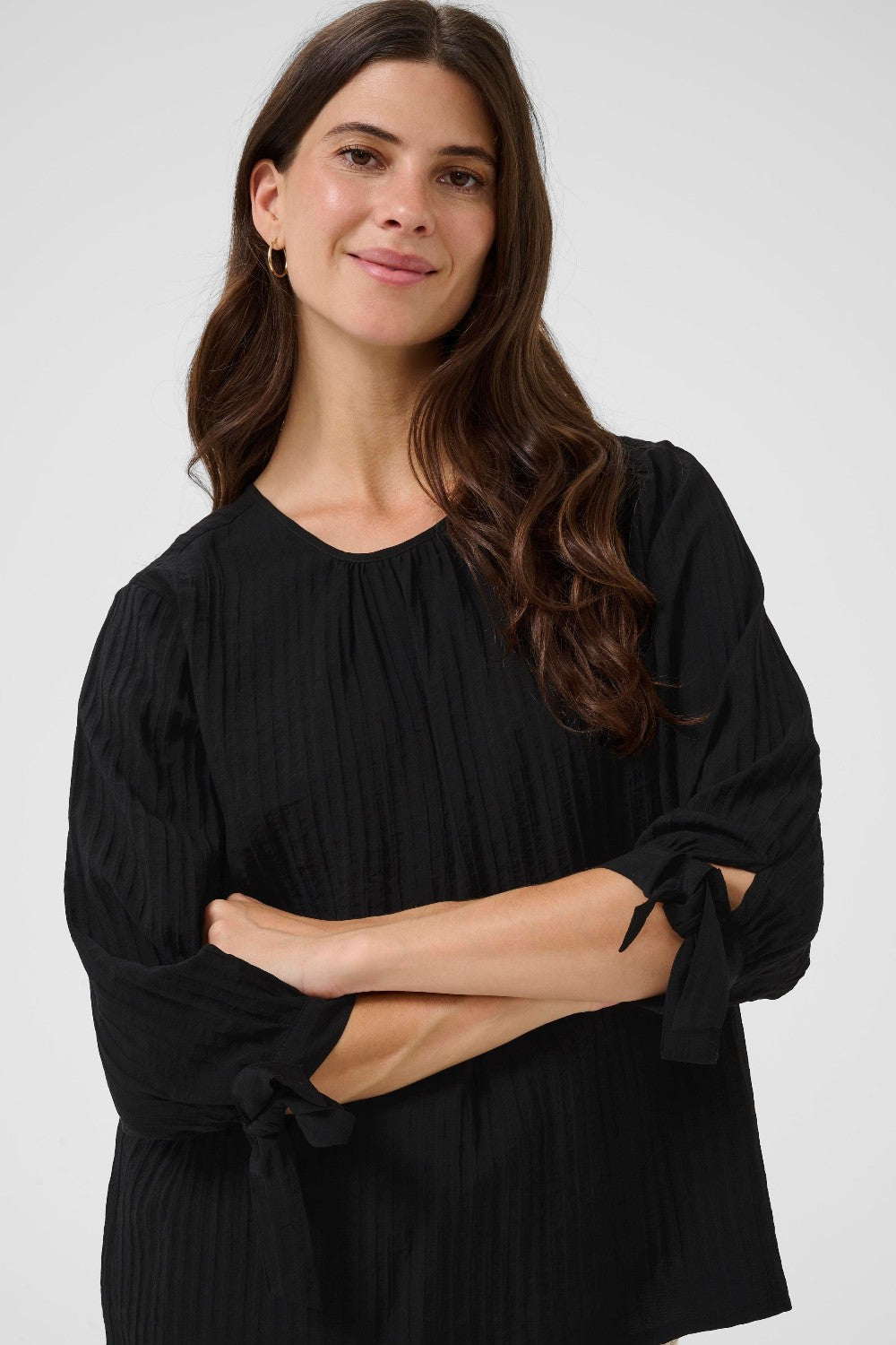 Woman wearing a black blouse against a white background
