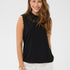 Woman wearing a black sleeveless top with lace details on a white background