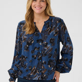 Woman wearing a blue floral blouse on a white background