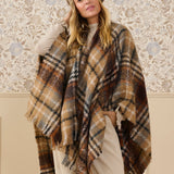 Upgrade your wardrobe with our Cream Tika Cape. Made with luxurious plaid fabric, this cape will wrap you in both comfort and style. Perfect for any occasion, take your outfit to the next level with this versatile and fashionable piece.