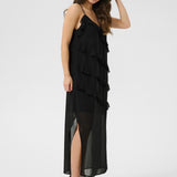 Woman wearing a black ruffled dress on a white background