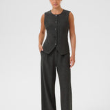 Woman wearing a gray pinstripe vest and pants on a white background