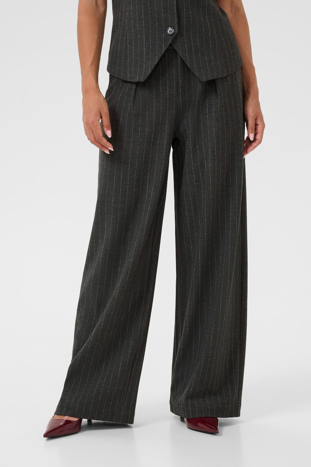 Person wearing a gray pinstripe suit on a white background