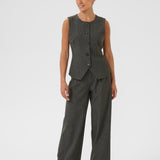 Woman wearing a gray pinstripe suit on a white background