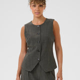 Woman wearing a gray pinstripe vest and pants on a white background
