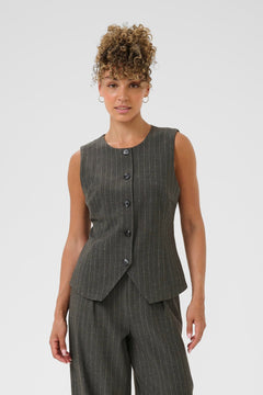Woman wearing a gray pinstripe vest and pants on a white background