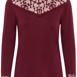 Maroon long-sleeve top with lace details on neckline and cuffs against a white background