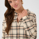 Woman wearing a plaid shirt against a white background