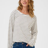 Woman wearing a striped long-sleeve shirt and blue jeans on a white background