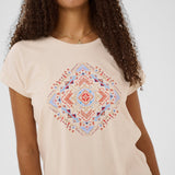 Woman wearing a beige t-shirt with a colorful geometric pattern on a white background