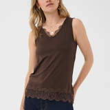 Woman wearing a brown sleeveless top with lace trim on a white background
