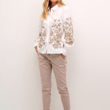 Introducing the Cream Daisy Shirt, a classic Cream style that combines timeless elegance with modern charm. Made from 100% cotton, this shirt boasts a gorgeous embroidered floral pattern that adds a touch of femininity. Perfect for most occasions, this shirt is a must-have addition to your wardrobe.