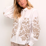 Introducing the Cream Daisy Shirt, a classic Cream style that combines timeless elegance with modern charm. Made from 100% cotton, this shirt boasts a gorgeous embroidered floral pattern that adds a touch of femininity. Perfect for most occasions, this shirt is a must-have addition to your wardrobe.