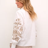 Introducing the Cream Daisy Shirt, a classic Cream style that combines timeless elegance with modern charm. Made from 100% cotton, this shirt boasts a gorgeous embroidered floral pattern that adds a touch of femininity. Perfect for most occasions, this shirt is a must-have addition to your wardrobe.