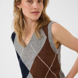 Woman wearing a sleeveless grey sweater featuring a dark blue and brown argyle design against a light background.