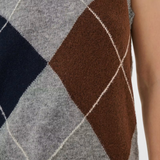 Close up of a sleeveless grey sweater featuring a dark blue and brown argyle design.