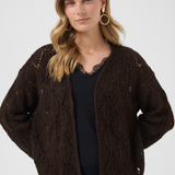 Woman wearing a brown knitted cardigan on a white background