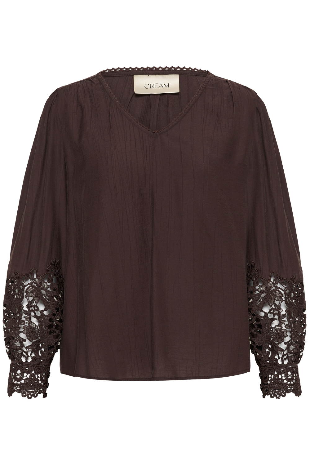 A dark brown crinkled blouse with long sheer sleeves featuring intricate floral lace cuffs, a V-neckline, and a cream-colored neck label that reads 'CREAM'.