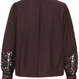 A dark brown long-sleeve blouse shown from the back, featuring a pleated texture, gathered shoulders, and intricate floral lace detailing on the cuffs.