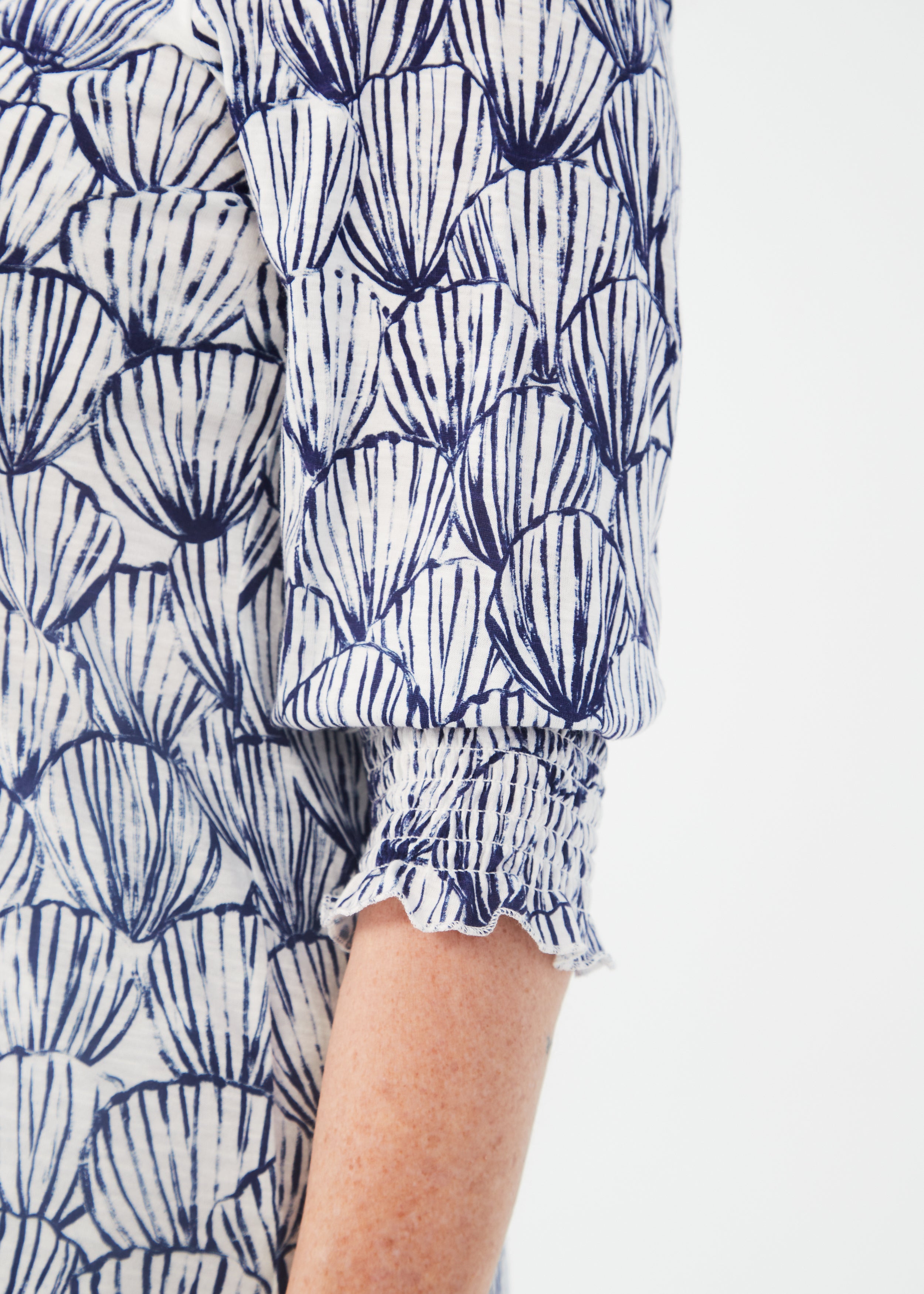 Introducing the FDJ Printed V-Neck Top with Smocked Cuffs, featuring a Shell Etching print in blue & white.