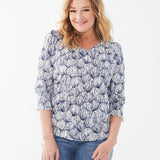 Introducing the FDJ Printed V-Neck Top with Smocked Cuffs, featuring a Shell Etching print in blue & white.