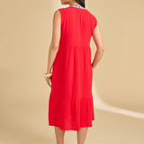 Woman wearing a red dress on a beige background